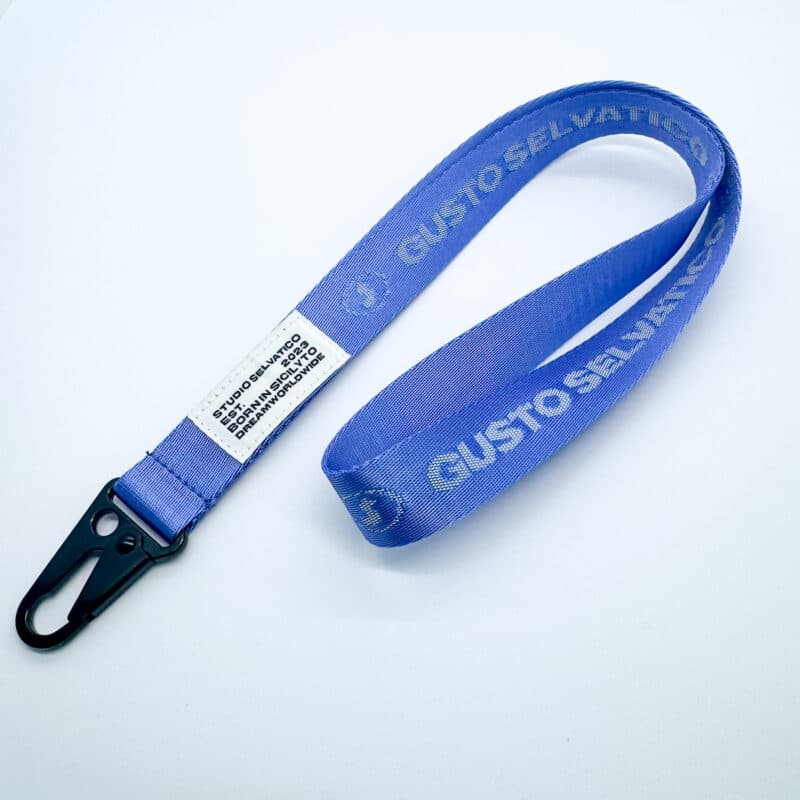 Custom woven conference lanyard printed with brand text and a black metal snap hook