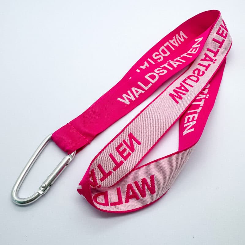 Pink double-sided woven lanyard with reversed brand print and a silver carabiner clip